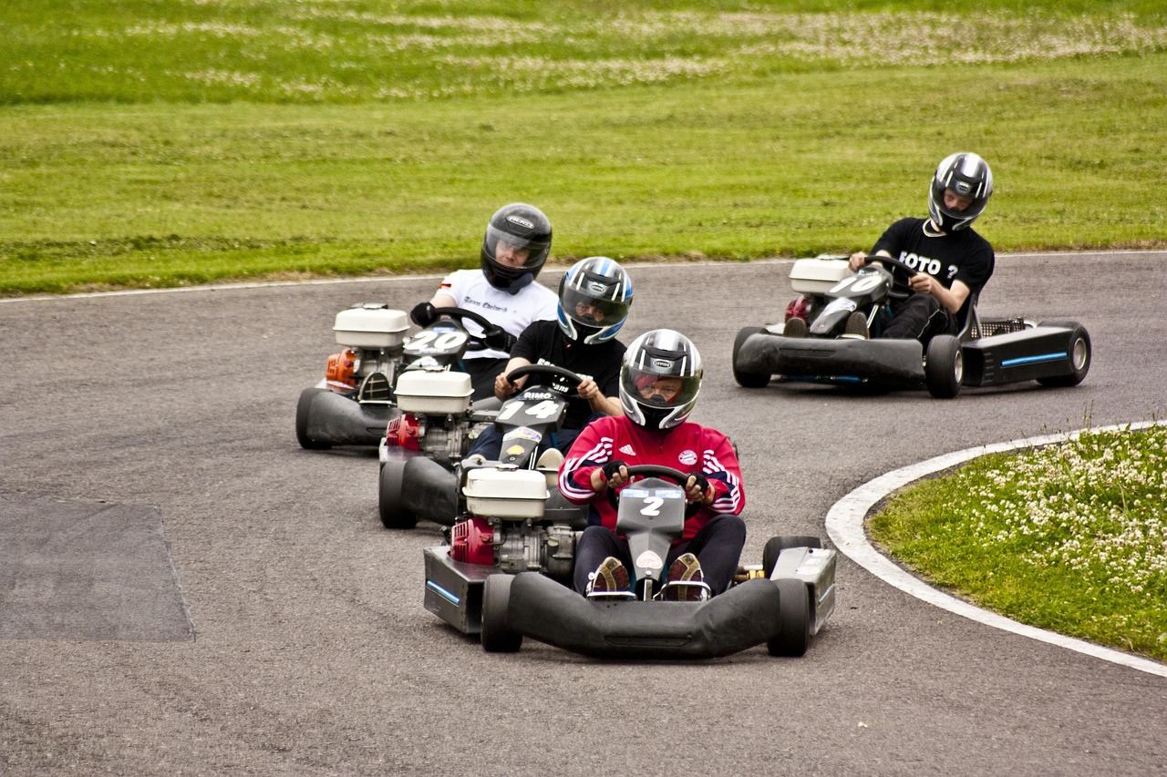 Four go-karts racing on a winding track, showcasing the excitement of kart racing. Is Kart Racing for you? Let's find ou