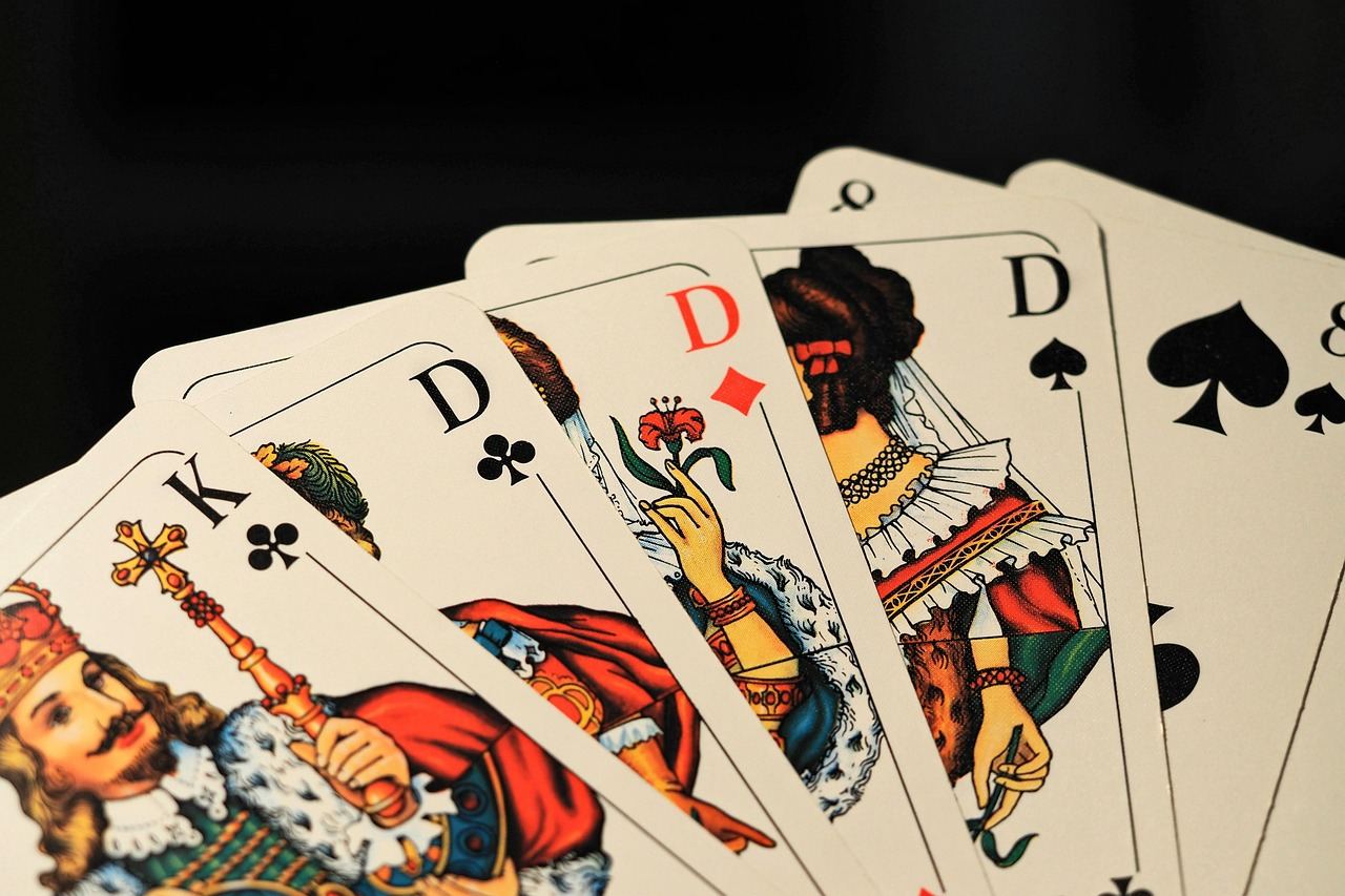 A colorful array of playing cards spread across a wooden table, showcasing various designs and game mechanics.