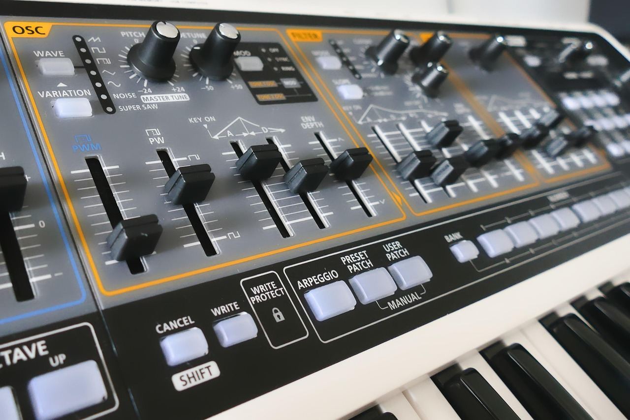 A colorful synthesizer with various knobs and sliders, set against a backdrop of vibrant sound waves.