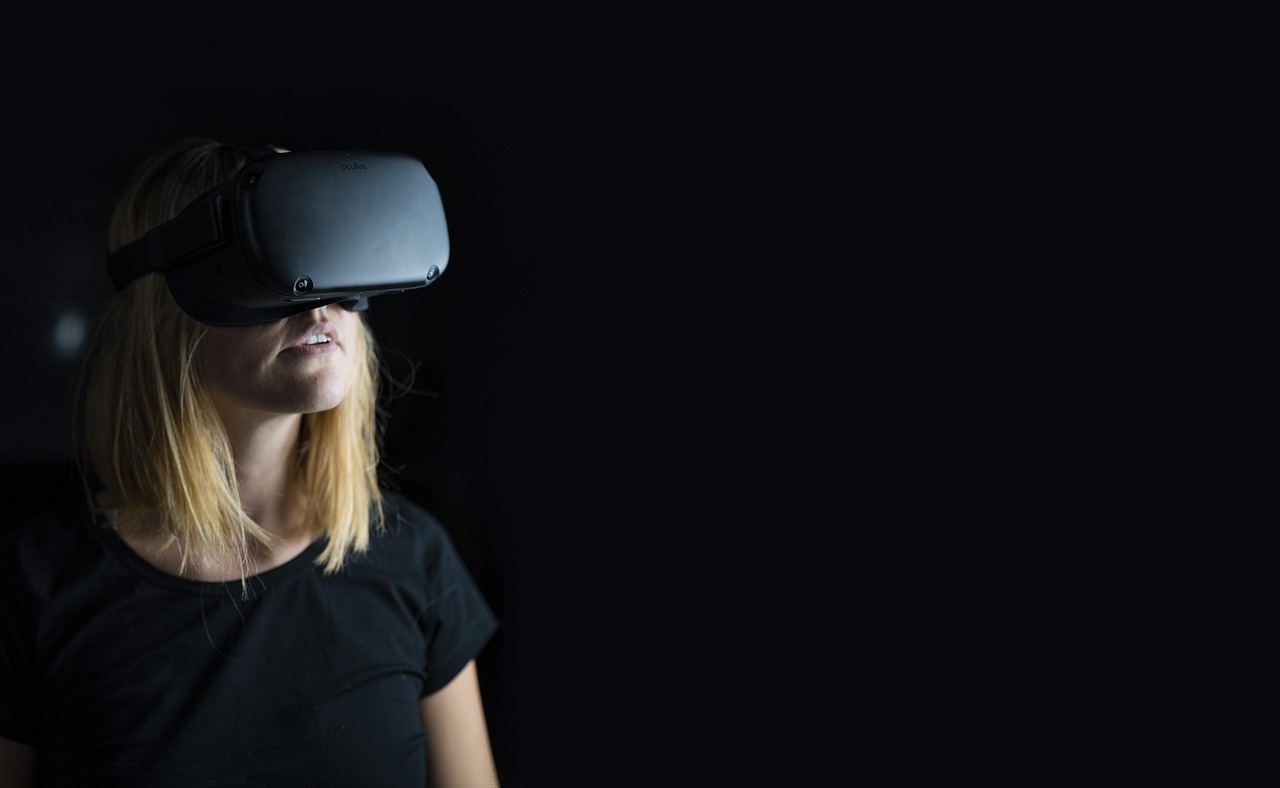 A group of people immersed in a vibrant virtual reality experience, wearing headsets and interacting with digital environments.