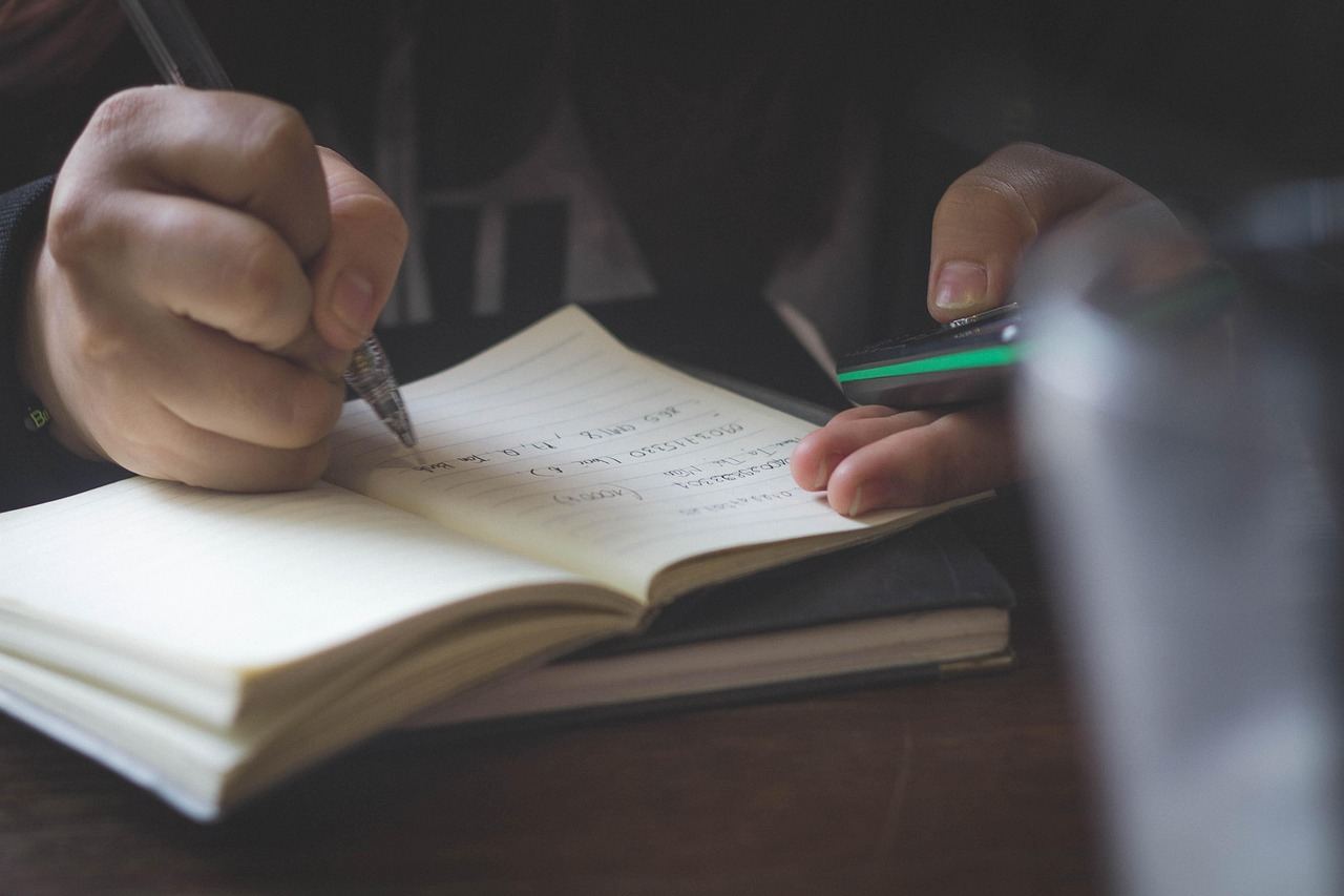 A person writing notes in a notebook, reflecting on the question: Is History Study for you? Let's find out.