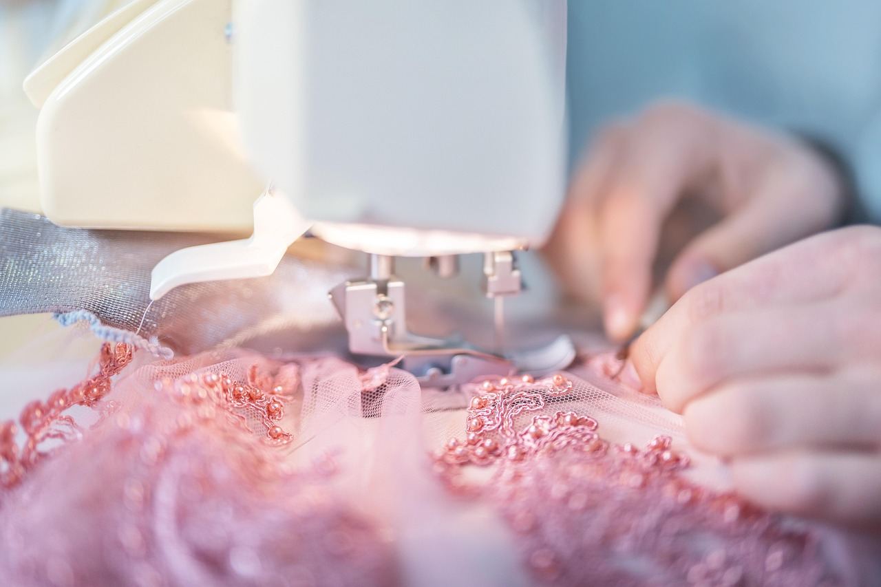 Close-up of hands using a sewing machine to create custom garments. Is Sewing for you? Let's find out!