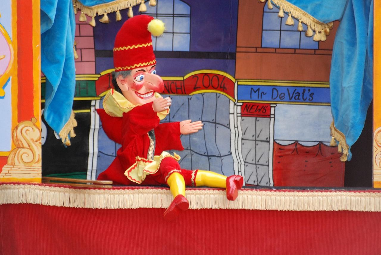 A vibrant Punchinello puppet with a colorful costume and exaggerated features, ready to entertain an audience.