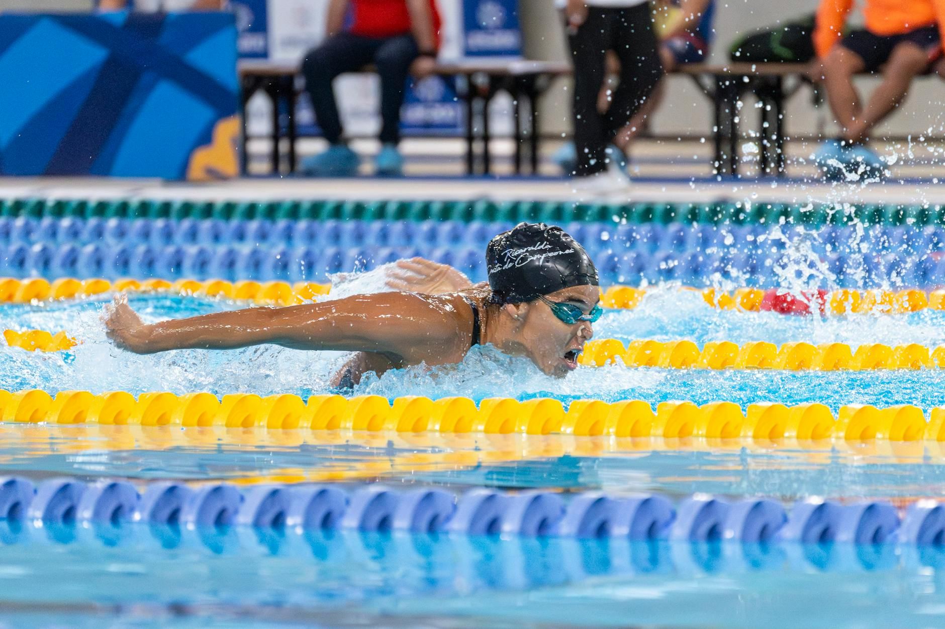 A swimmer in a race swimming the butterfly stroke during a competitive event.