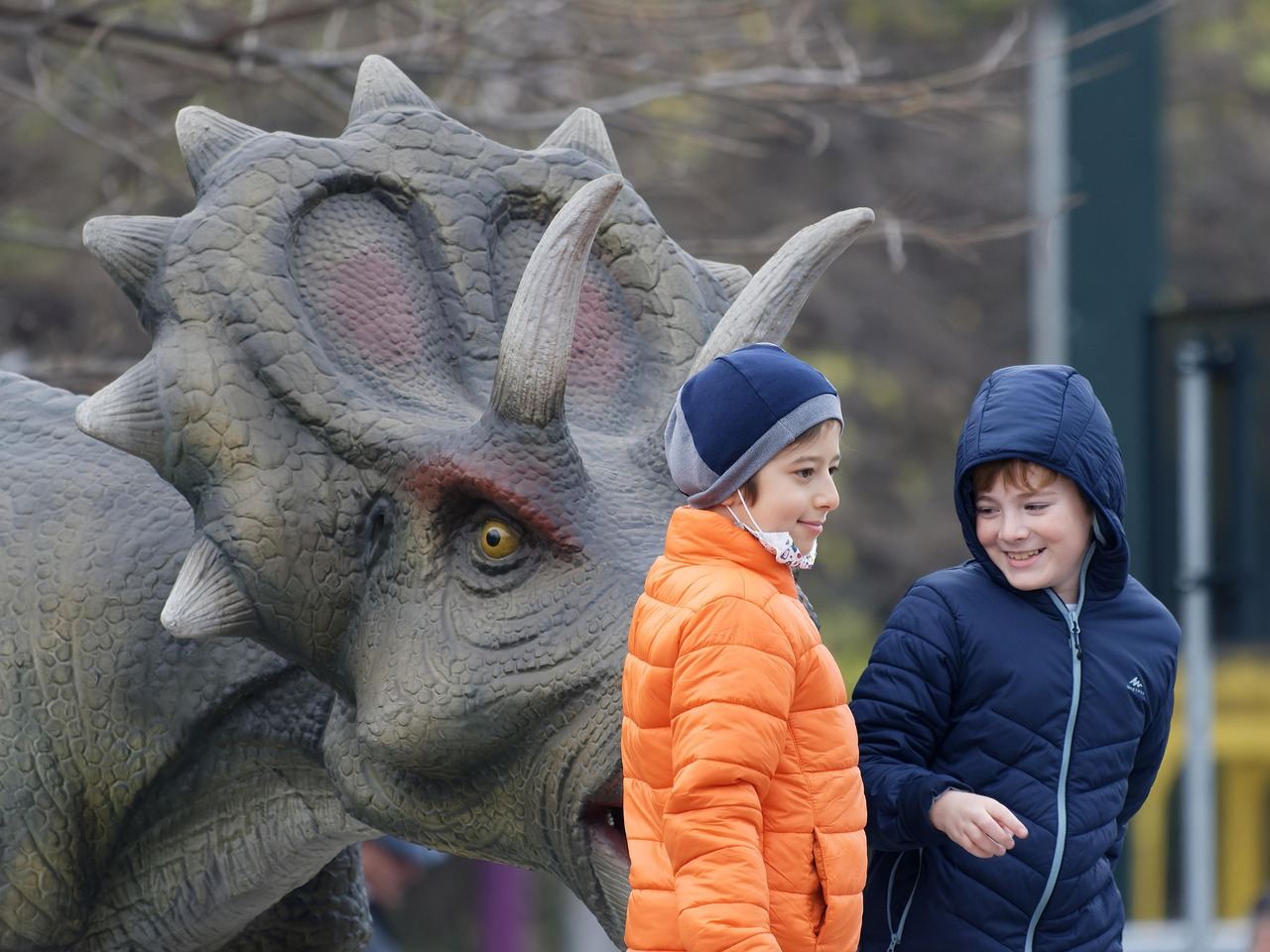 A group of diverse children joyfully engaging in hands-on exhibits at a colorful children's museum.