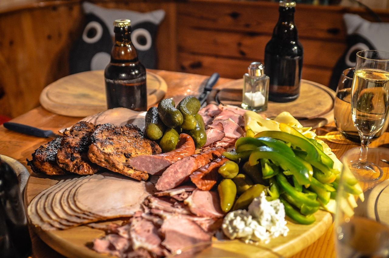 A beautifully arranged charcuterie board featuring an assortment of cured meats, cheeses, fruits, and nuts on a rustic wooden table.
