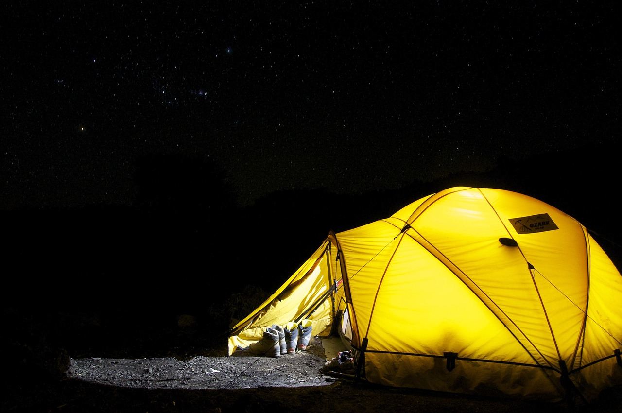 A bright yellow tent under a starry sky, perfect for backcountry camping adventures. Is Backcountry Camping for you? Let