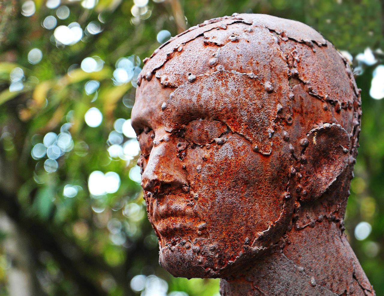 A rusted sculpture resembling a human head, exploring themes of found object art. Is Found Object Art for you? Let's fin