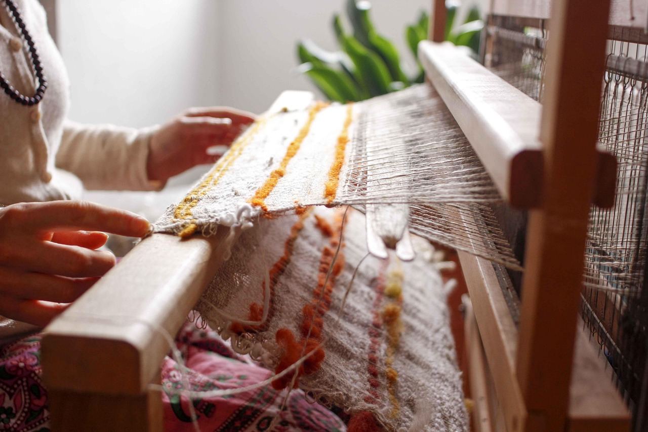 A beautifully crafted wooden loom set up with colorful threads, ready for weaving intricate patterns.