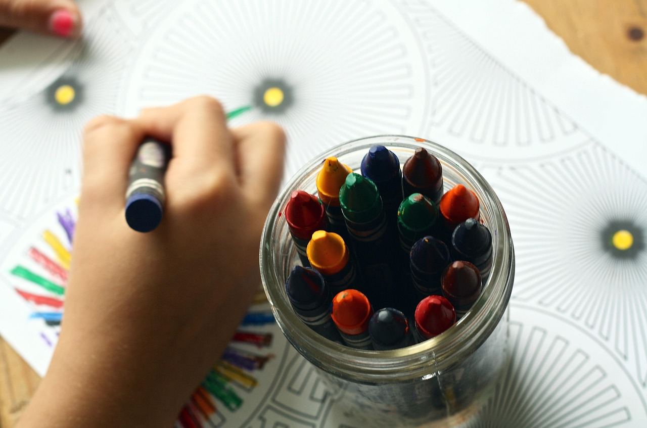 A vibrant array of colorful crayons arranged neatly, inviting creativity and relaxation through adult coloring.