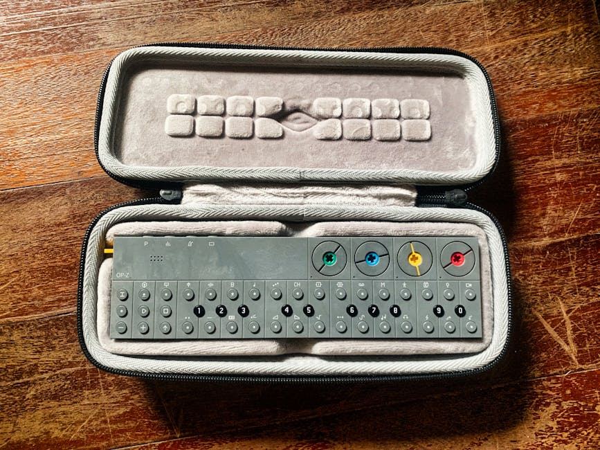 A synthesizer in a protective case, showcasing its keys and colorful audio jacks.