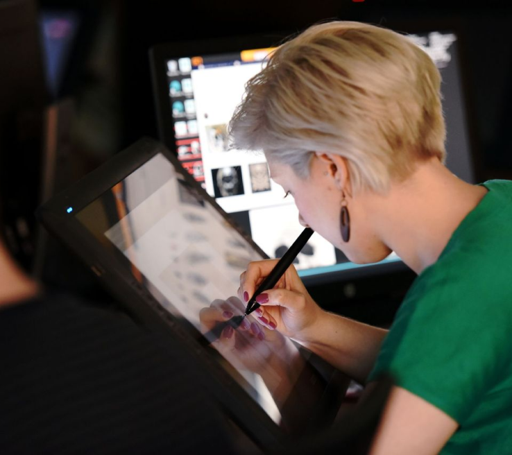 A woman drawing in a tablet