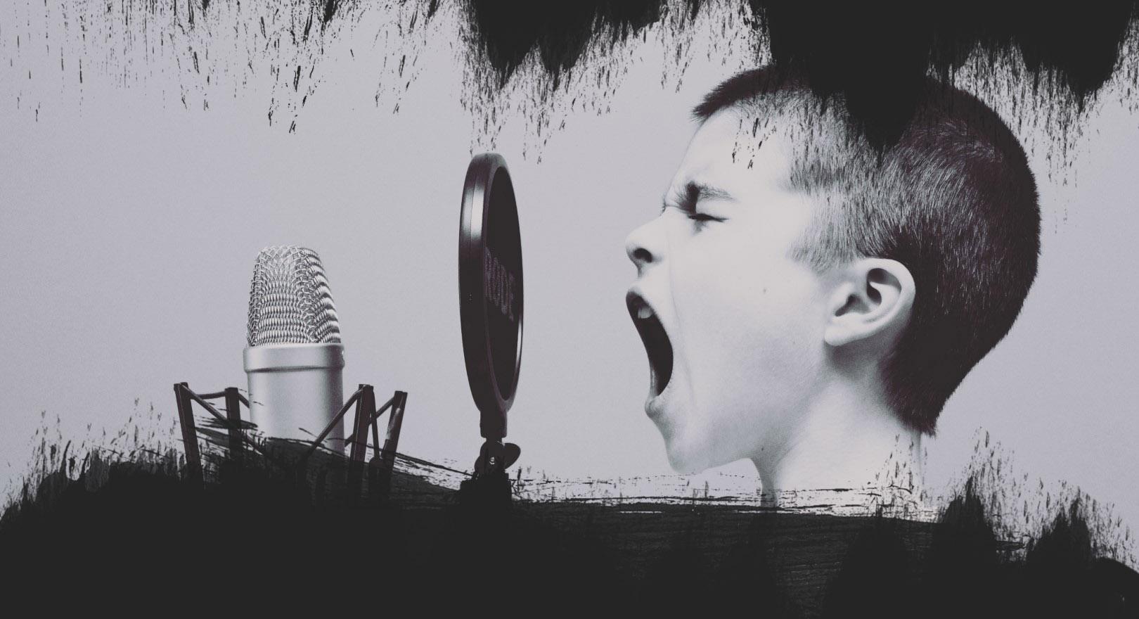 A children singing in a mic.