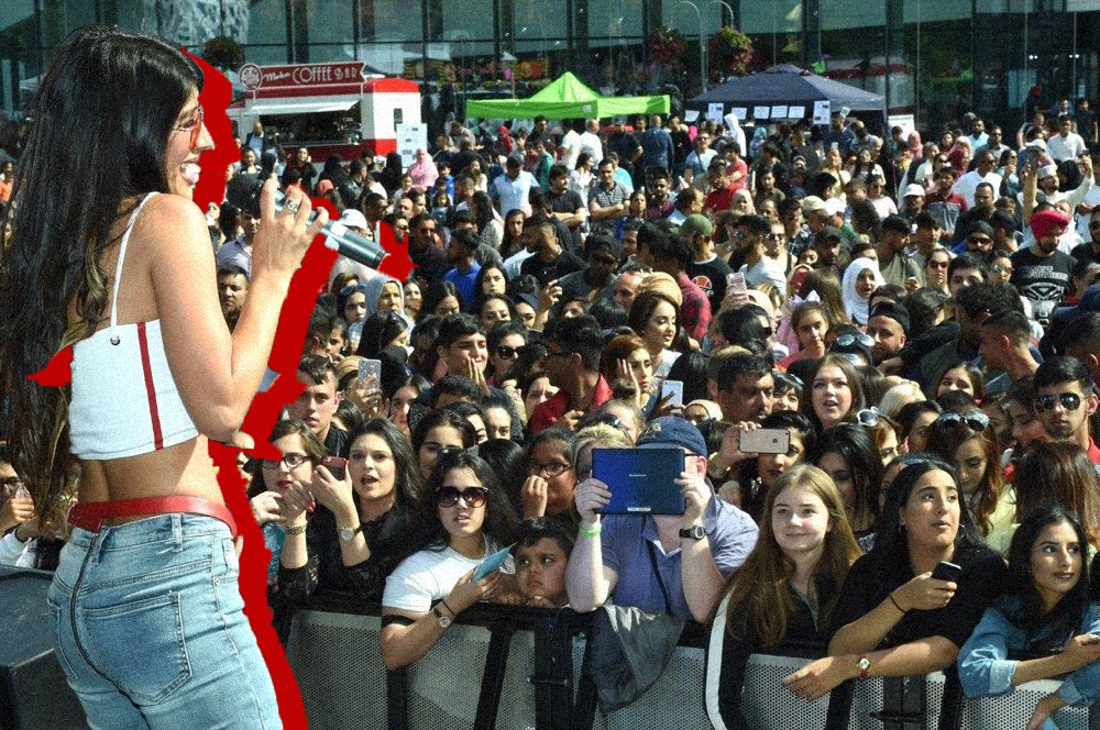 Woman singing to the crowd.