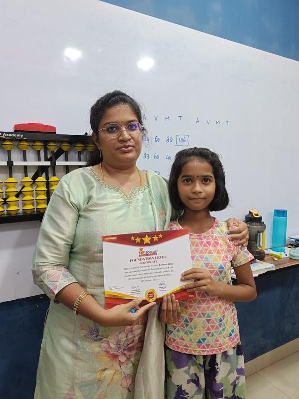 A student receiving her Foundation level certificate at SIP Abacus Adyar.