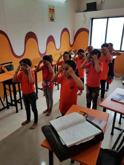 Students doing a Brain Gym exercise in class