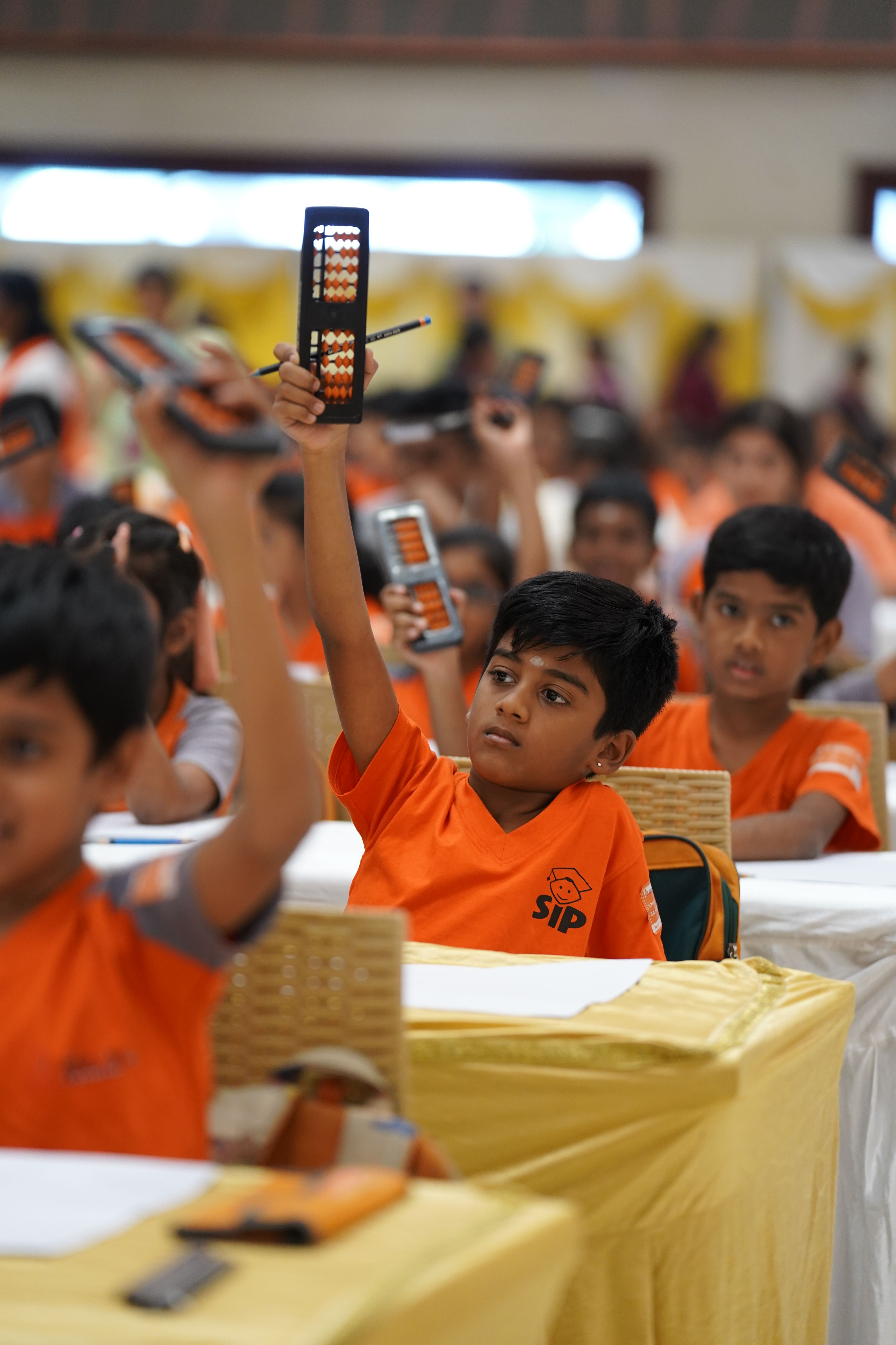 Students actively learning abacus techniques in a focused classroom session.