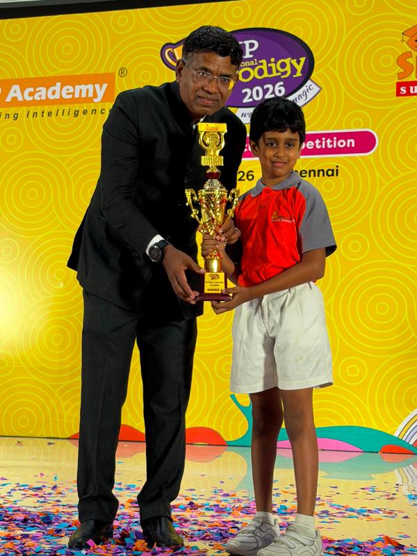 A SIP Abacus student receiving their competition trophy.