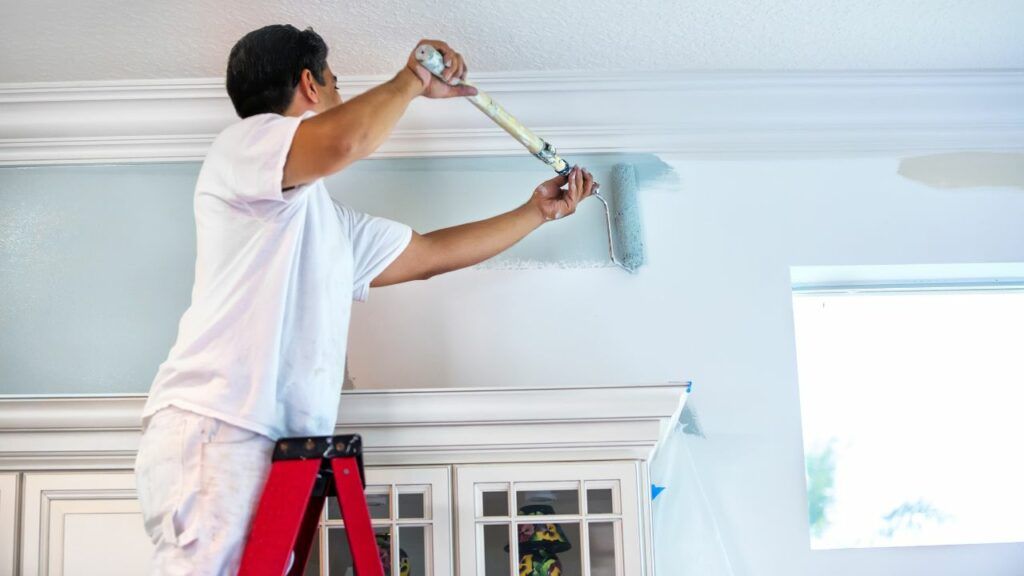 man-painting-wall