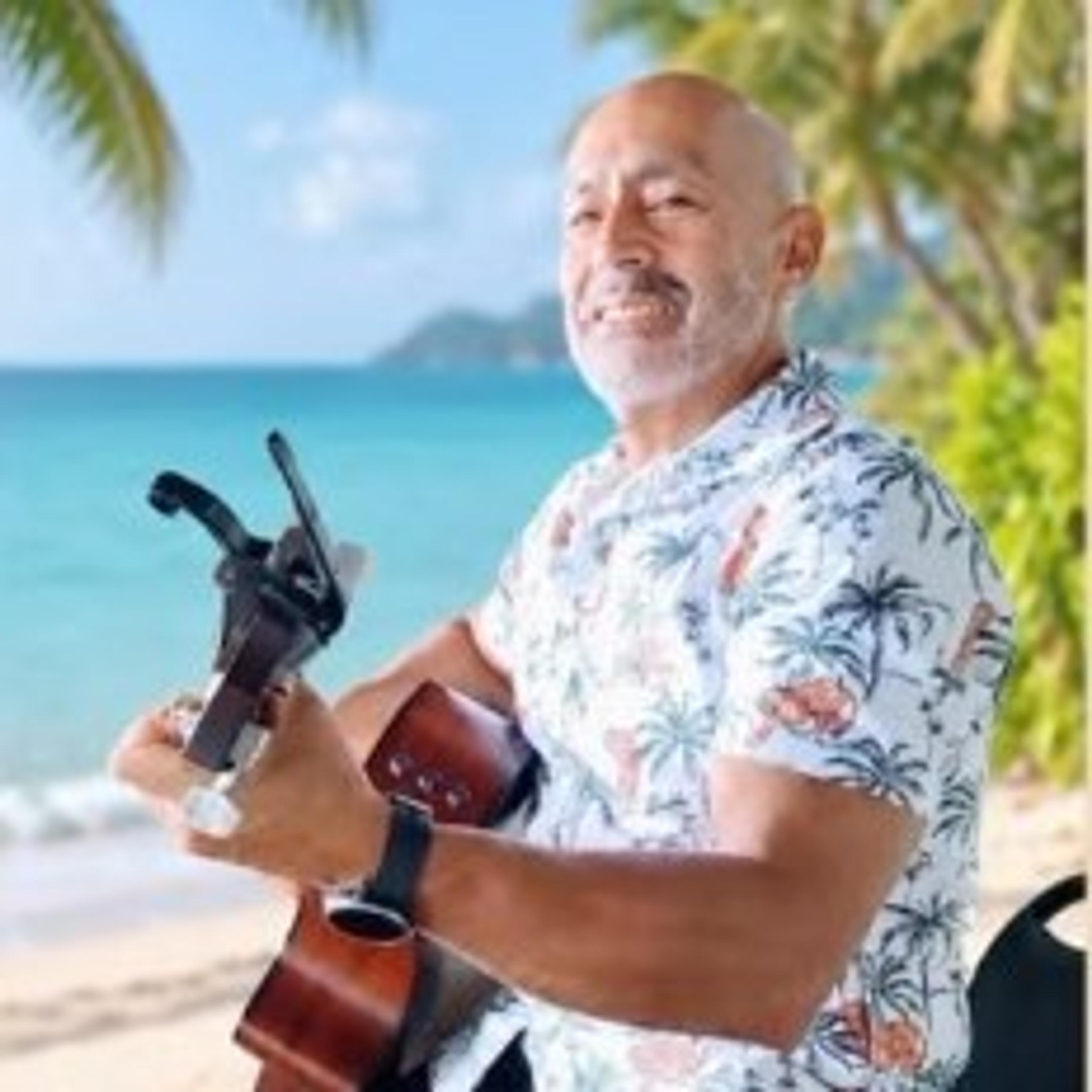 Val Vasquez playing ukulele on the beach