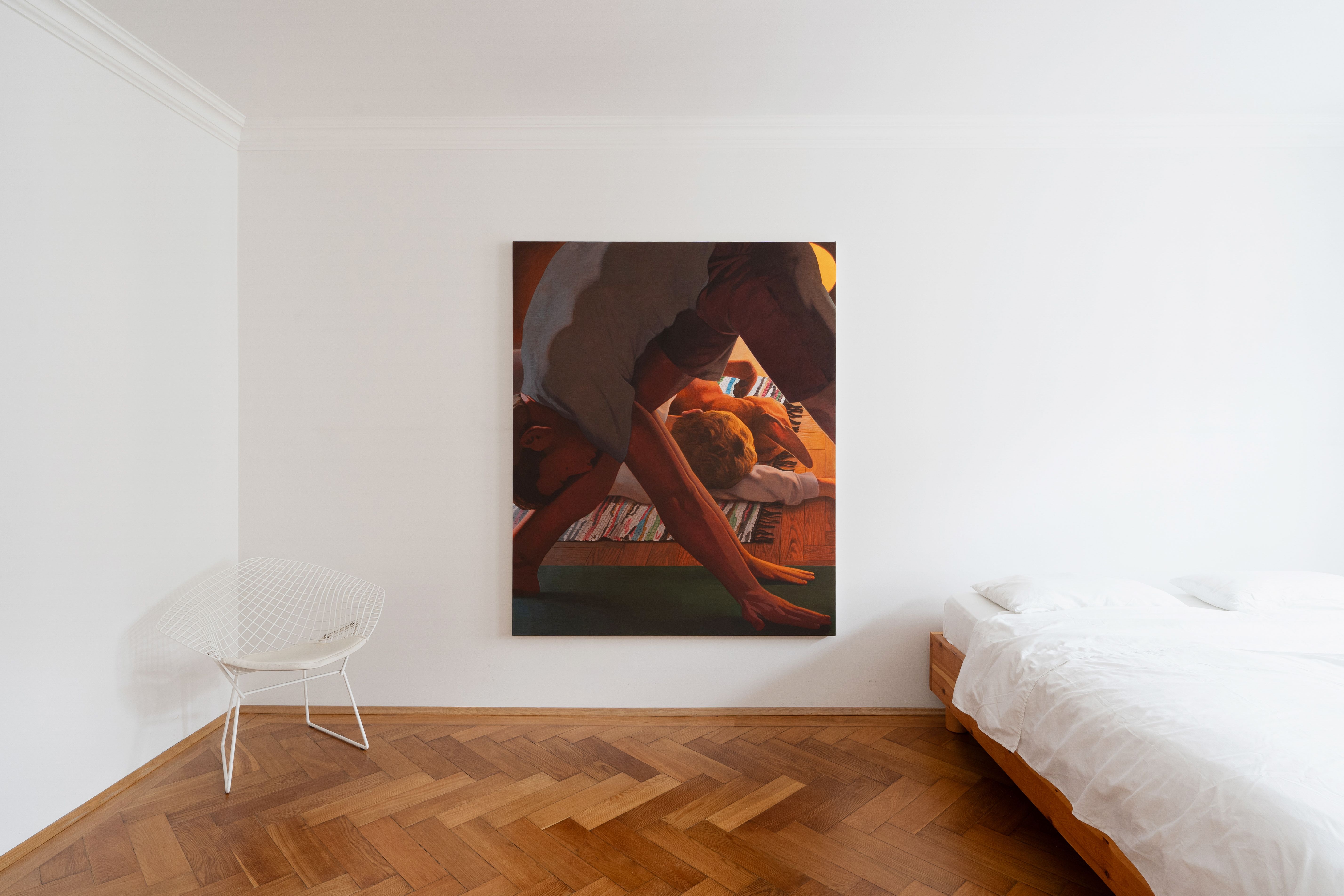 Installation shot of a painting in a domestic setting, the painting shows a man doing yoga and another man rolling on the floor with a dog
