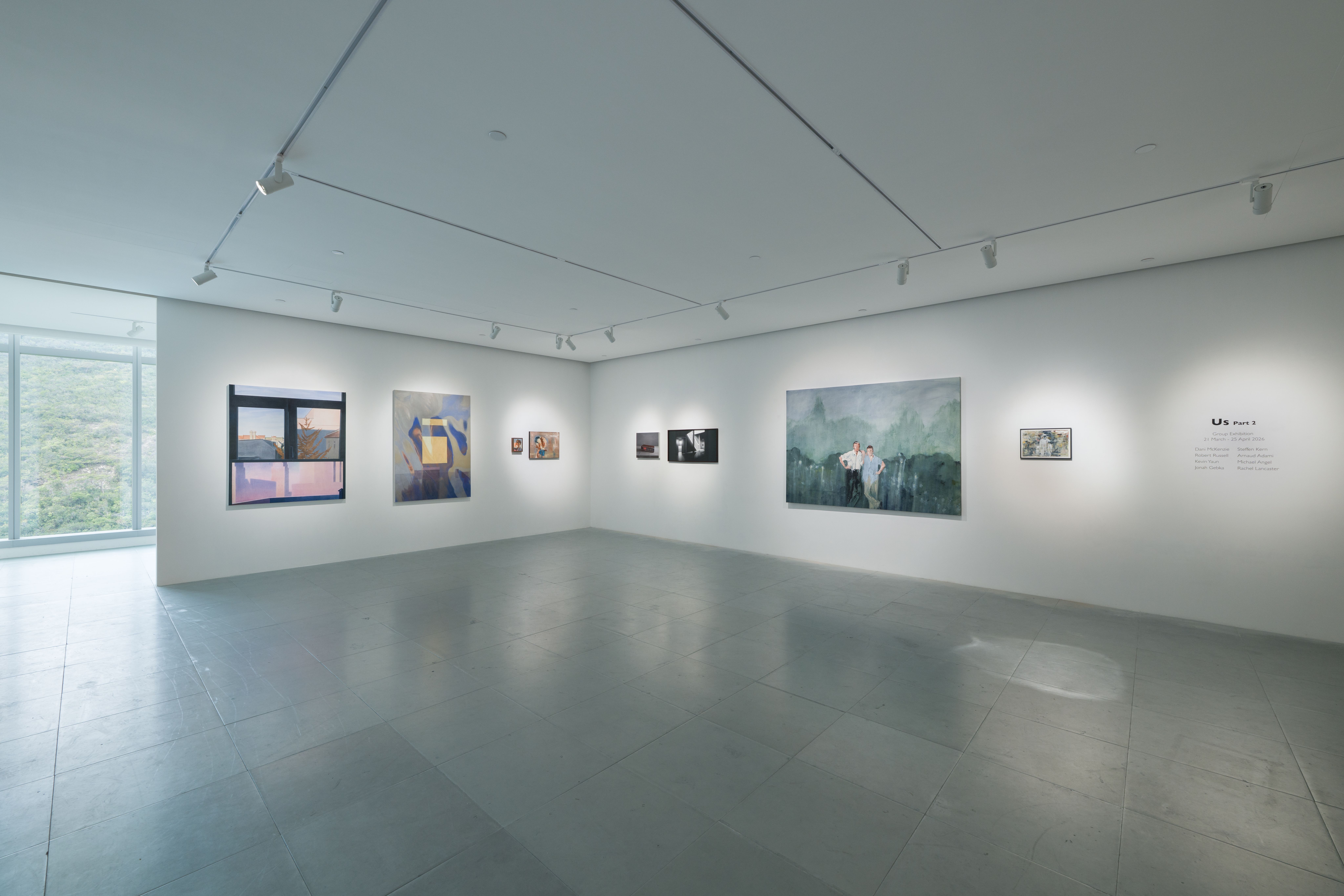 A gallery space with lots of paintings