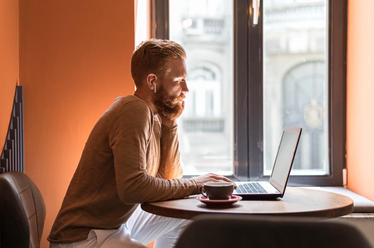 person integrating swiper js into their webflow project at a cafe drinking coffee