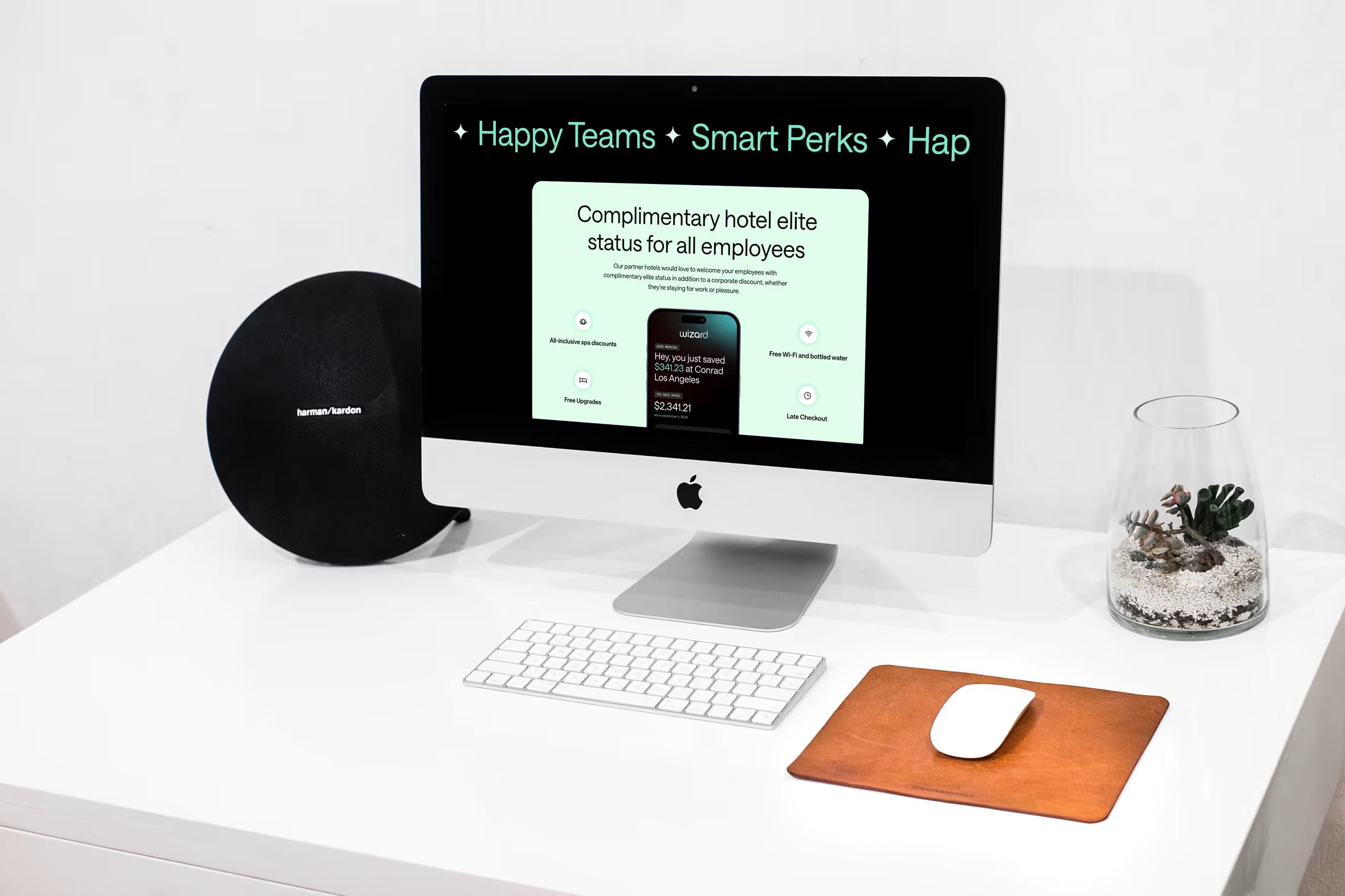 Wizard Perks hotel elite status section with Happy Teams Smart Perks marquee on iMac with Harman Kardon speaker