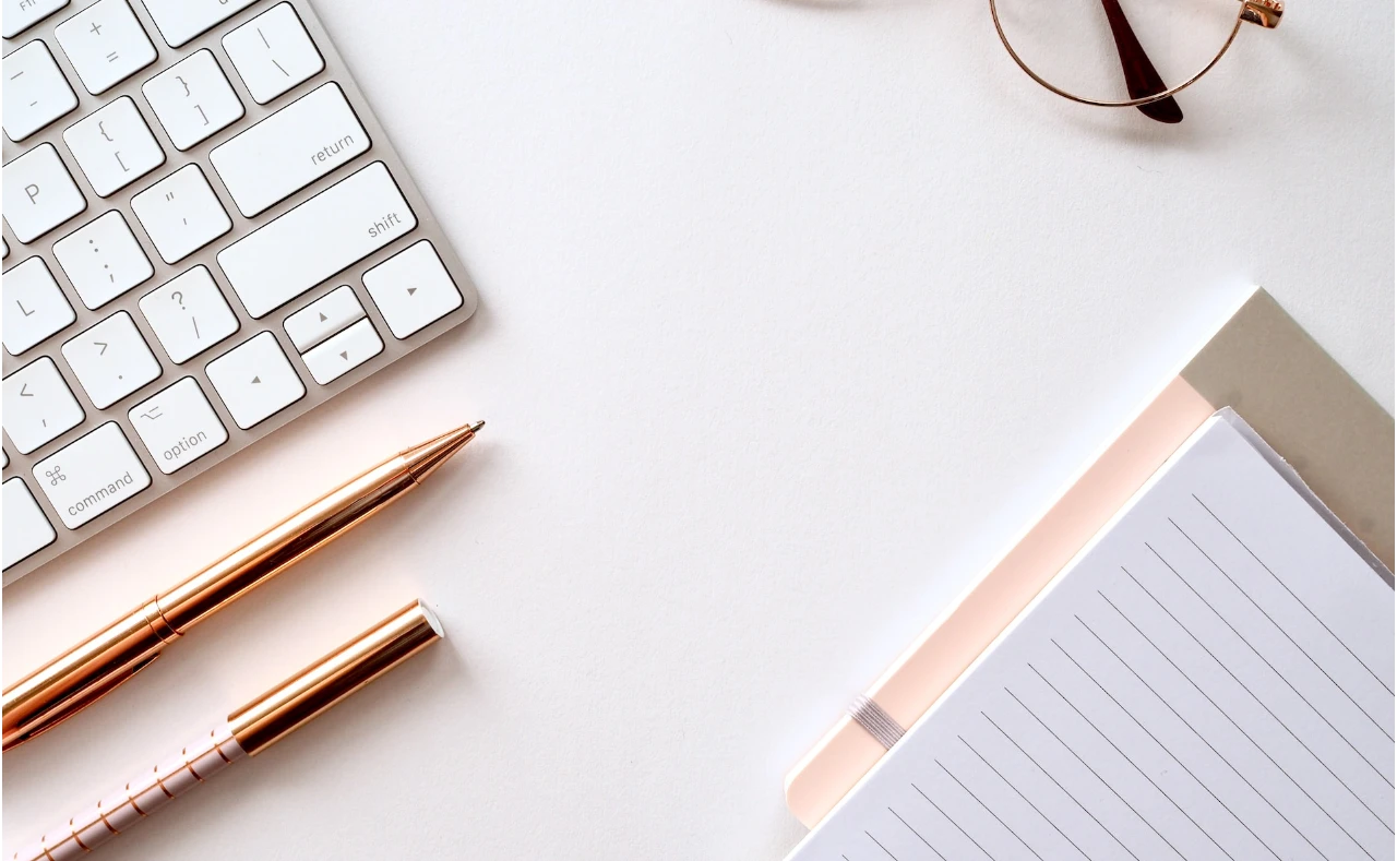 keyboard, paper, glasses on a desk for copywriting