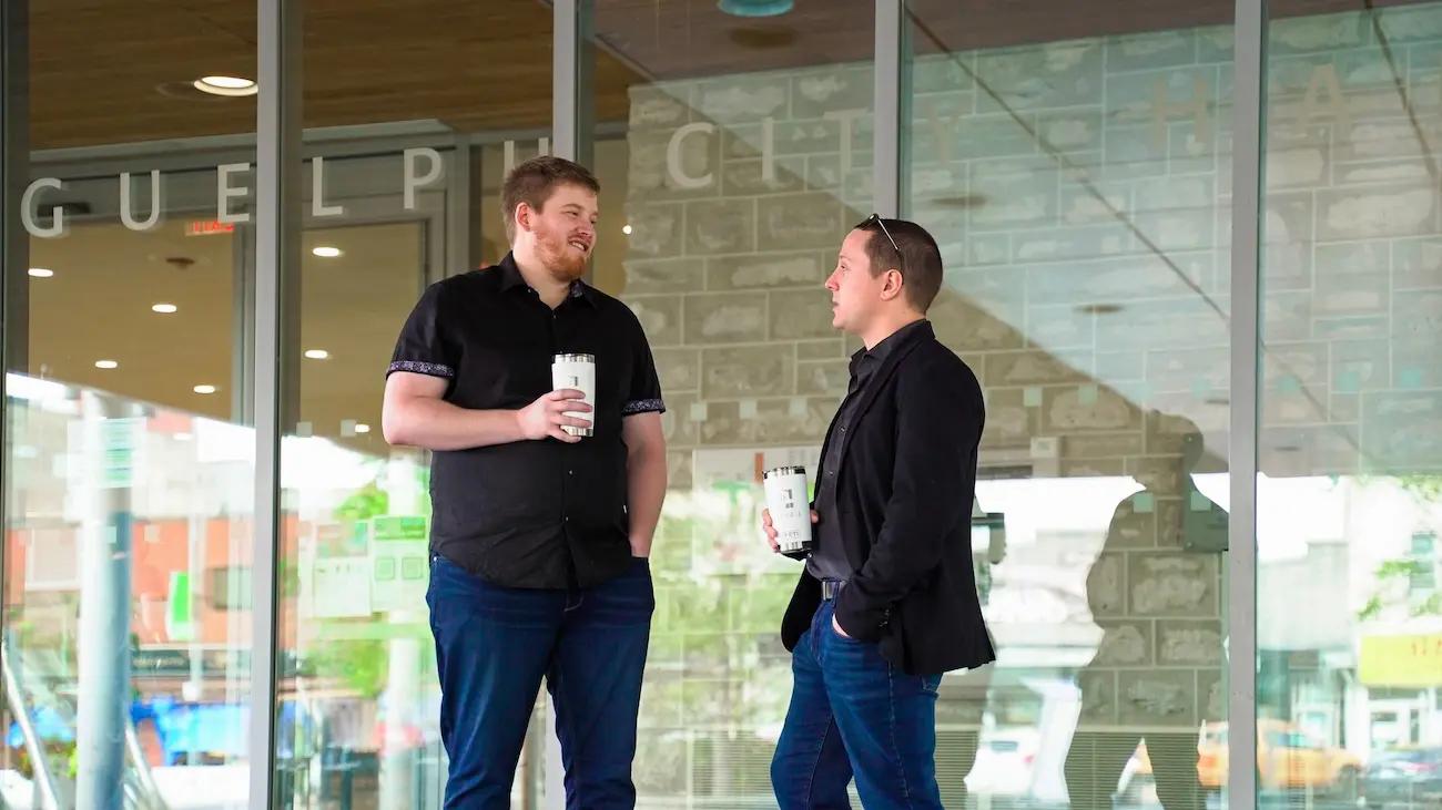 two men talking about their business, giving each other an elevator pitch.
