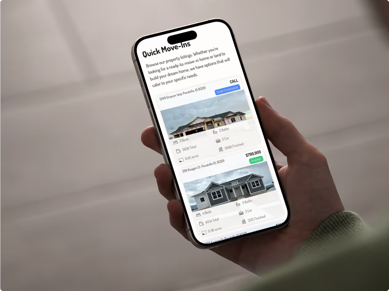 Hand holding iPhone showing Satterfield Builders Quick Move-Ins listing page with property cards displaying home exteriors, specs, and pricing at $789,900