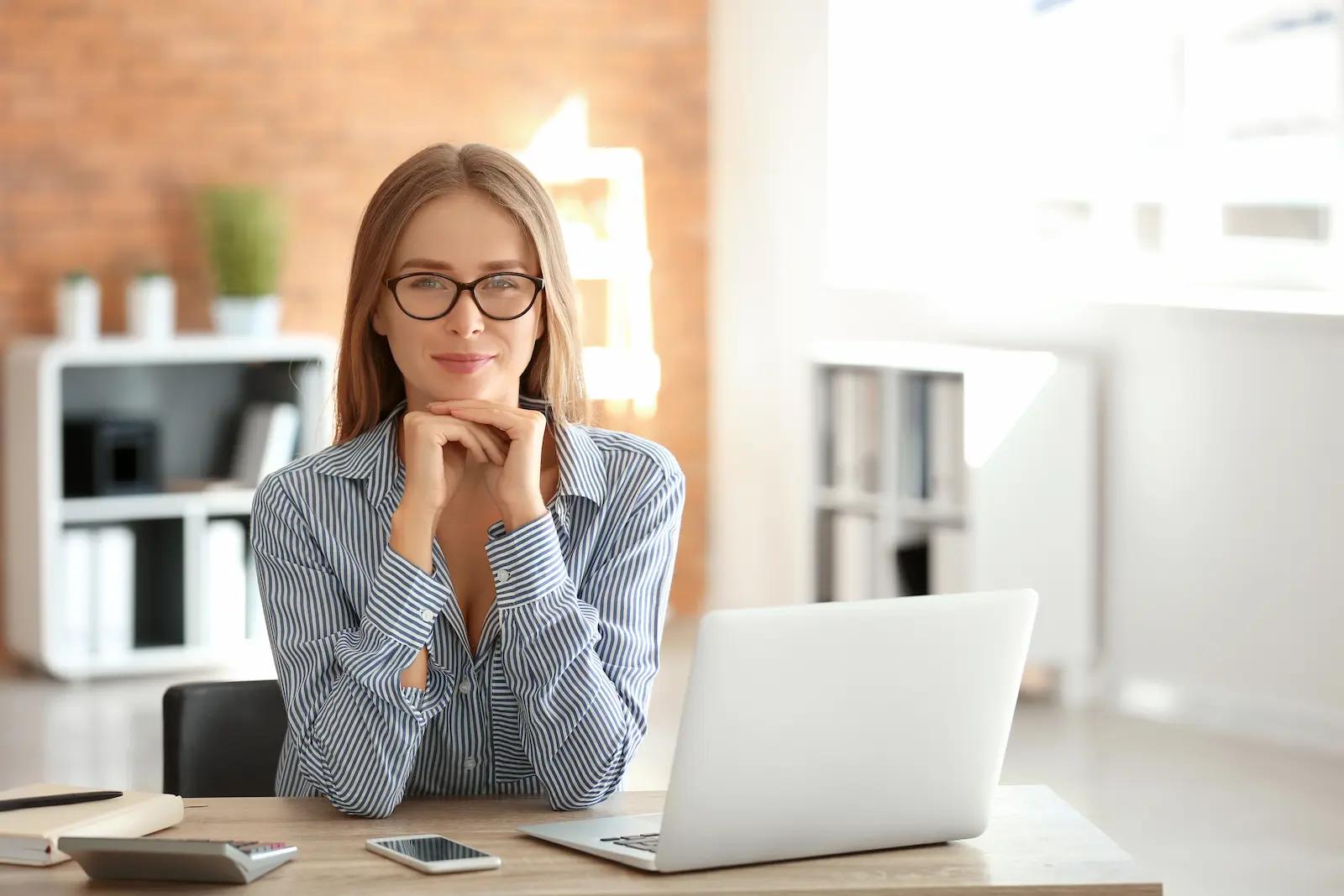 woman sitting at desk with a laptop on it
