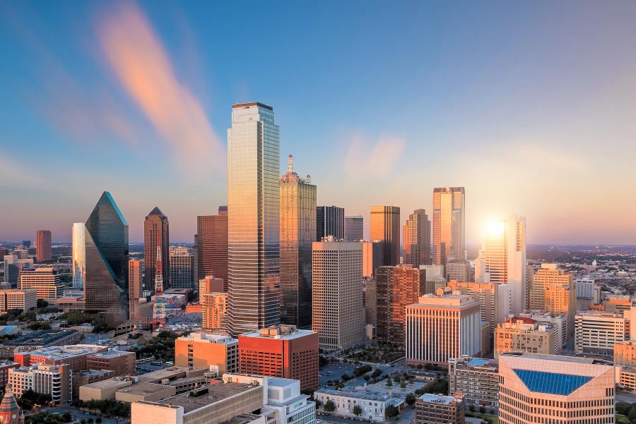 The sun setting behind the Downtown Dallas towers
