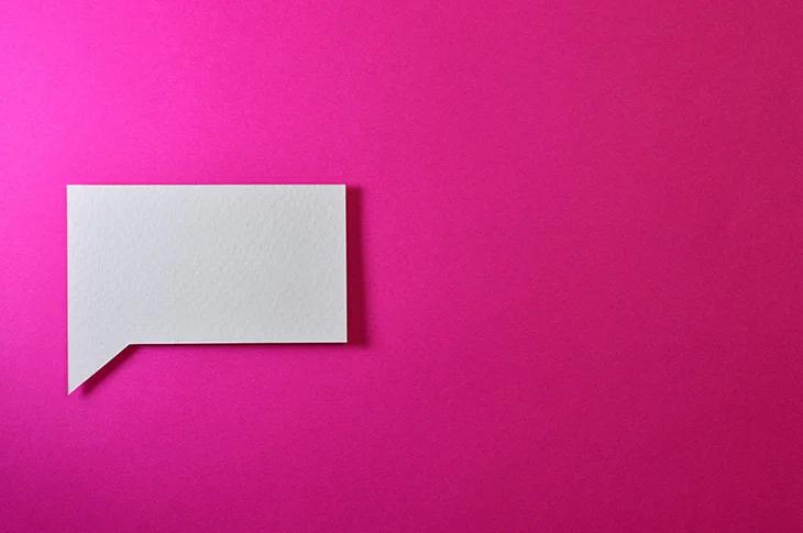a speech block against a bright pink background