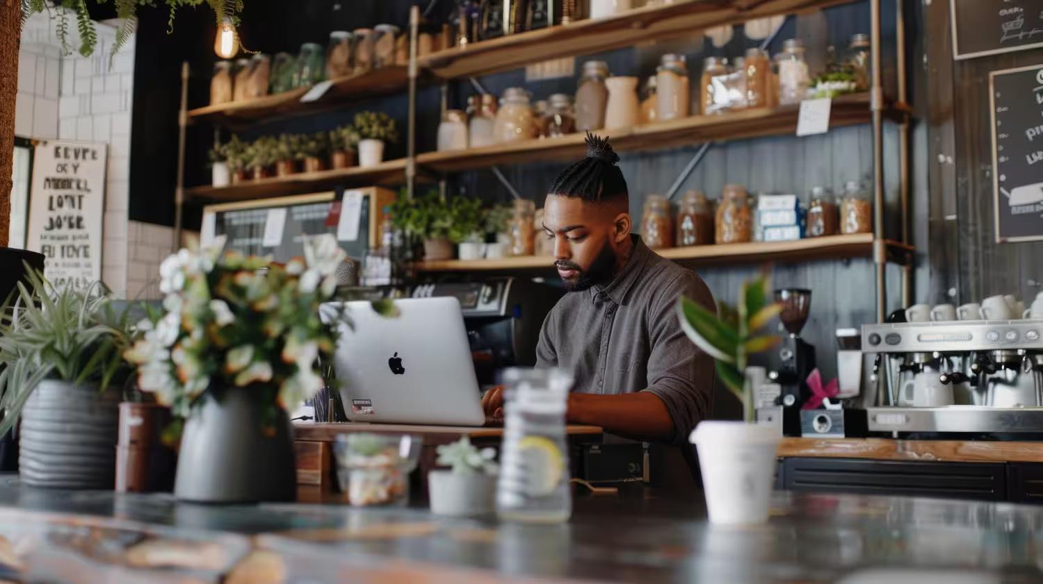 Small Business owner doing keyword research on a laptop in their business before customers arrive.