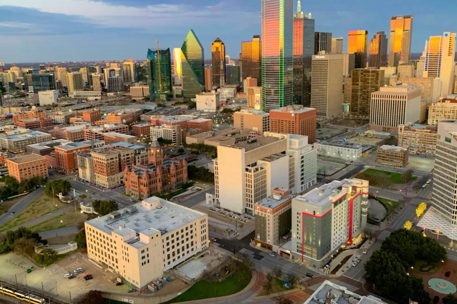 Aerial view of downtown Dallas at golden hour above the historic West End