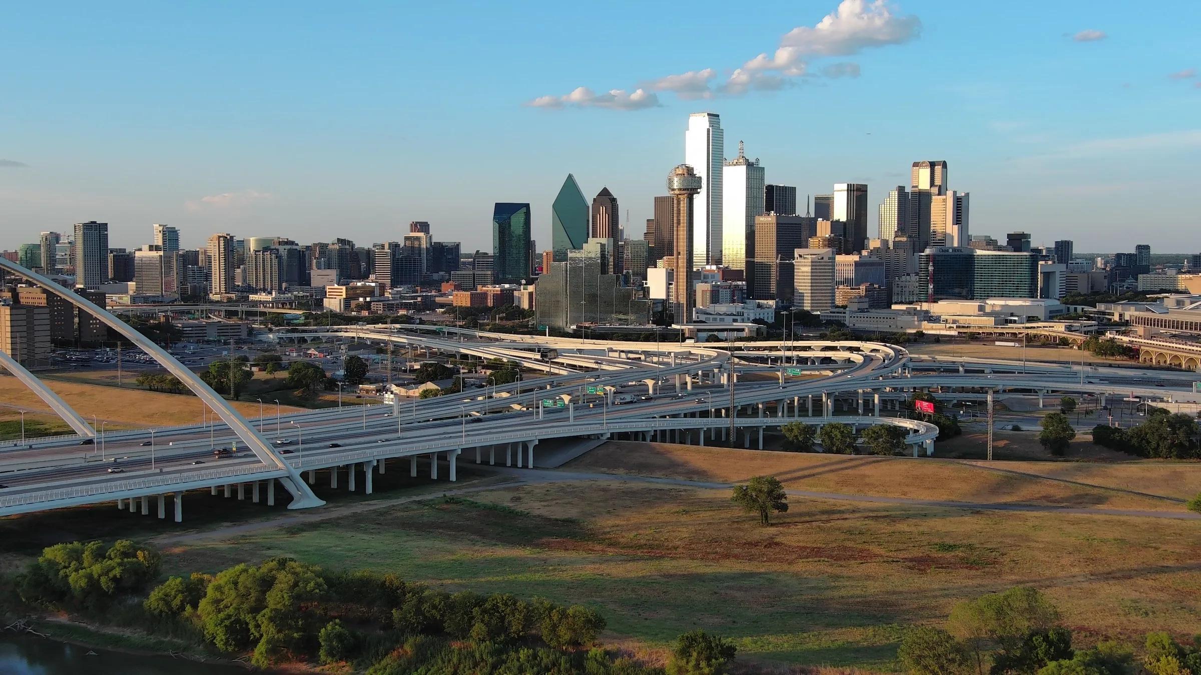 An aerial view of the Dallas skyline with the Margaret McDermott Bridge