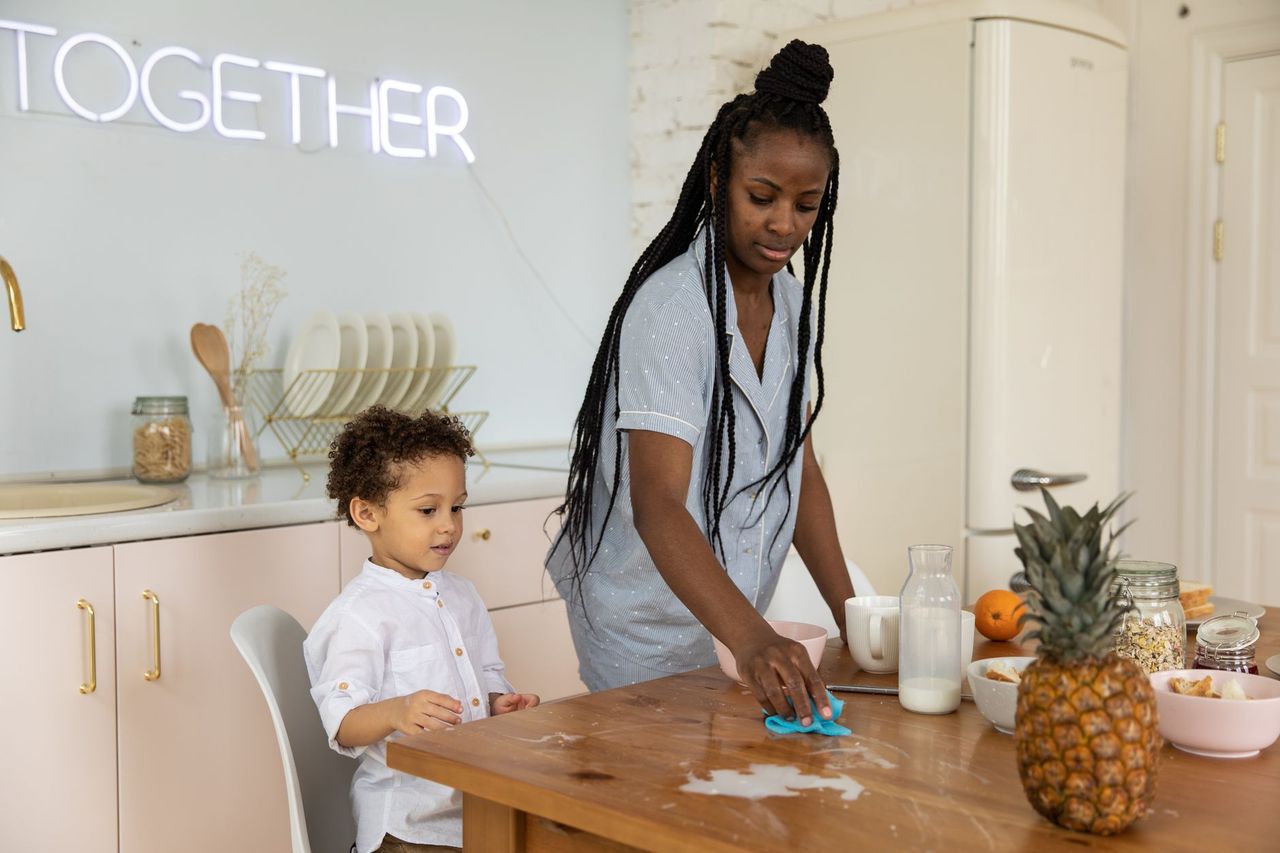 Simple chore card and visual timer placed beside household cleaning supplies