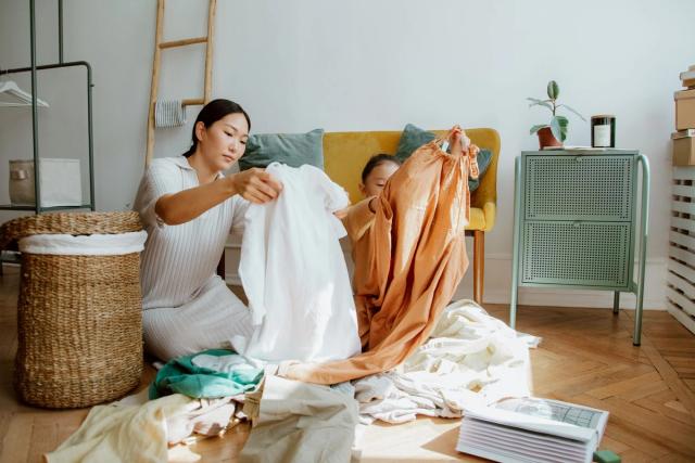 Tween following a household chore checklist while organising clothes and cleaning supplies