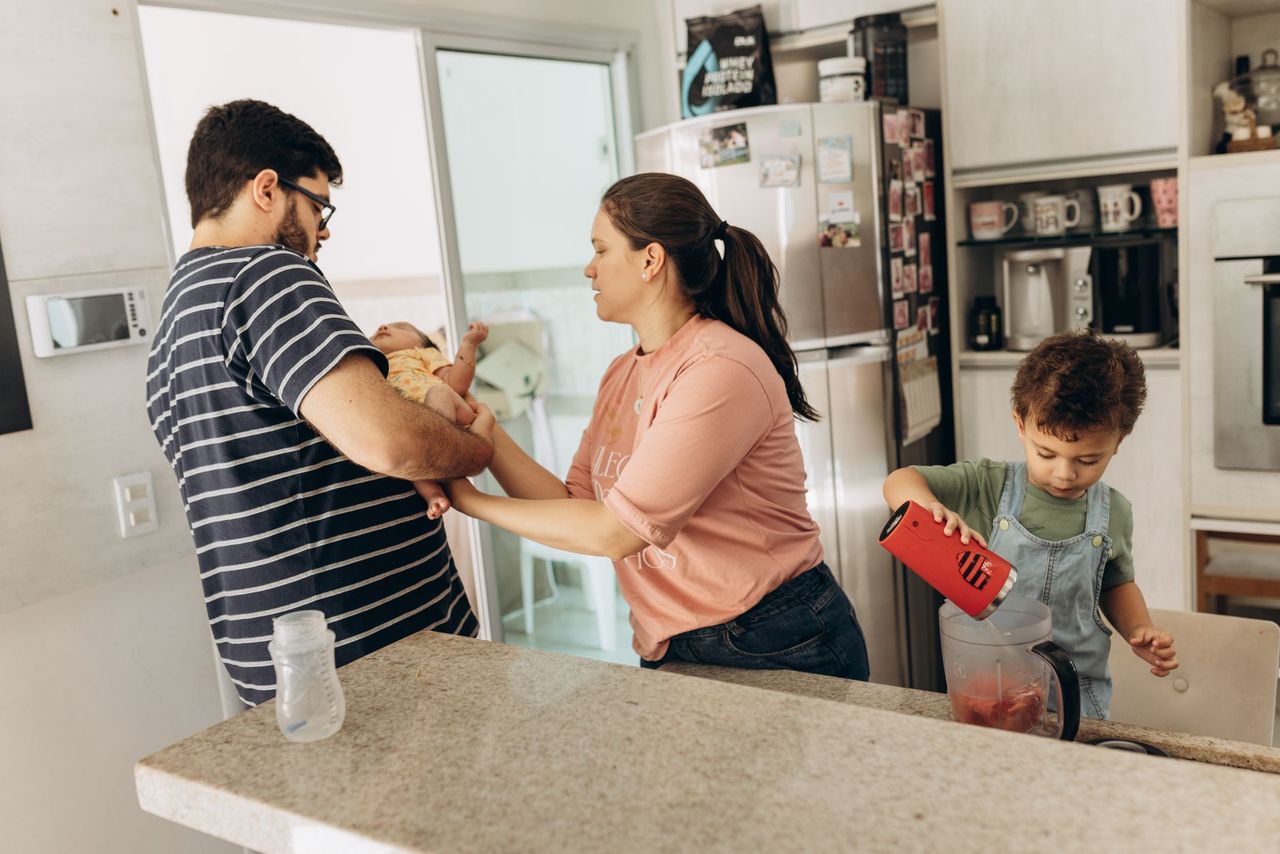 Parent and children looking at a simple household responsibility chart together