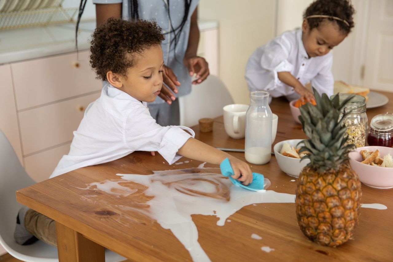 Family reviewing a shared responsibility system and a child’s routine checklist at home