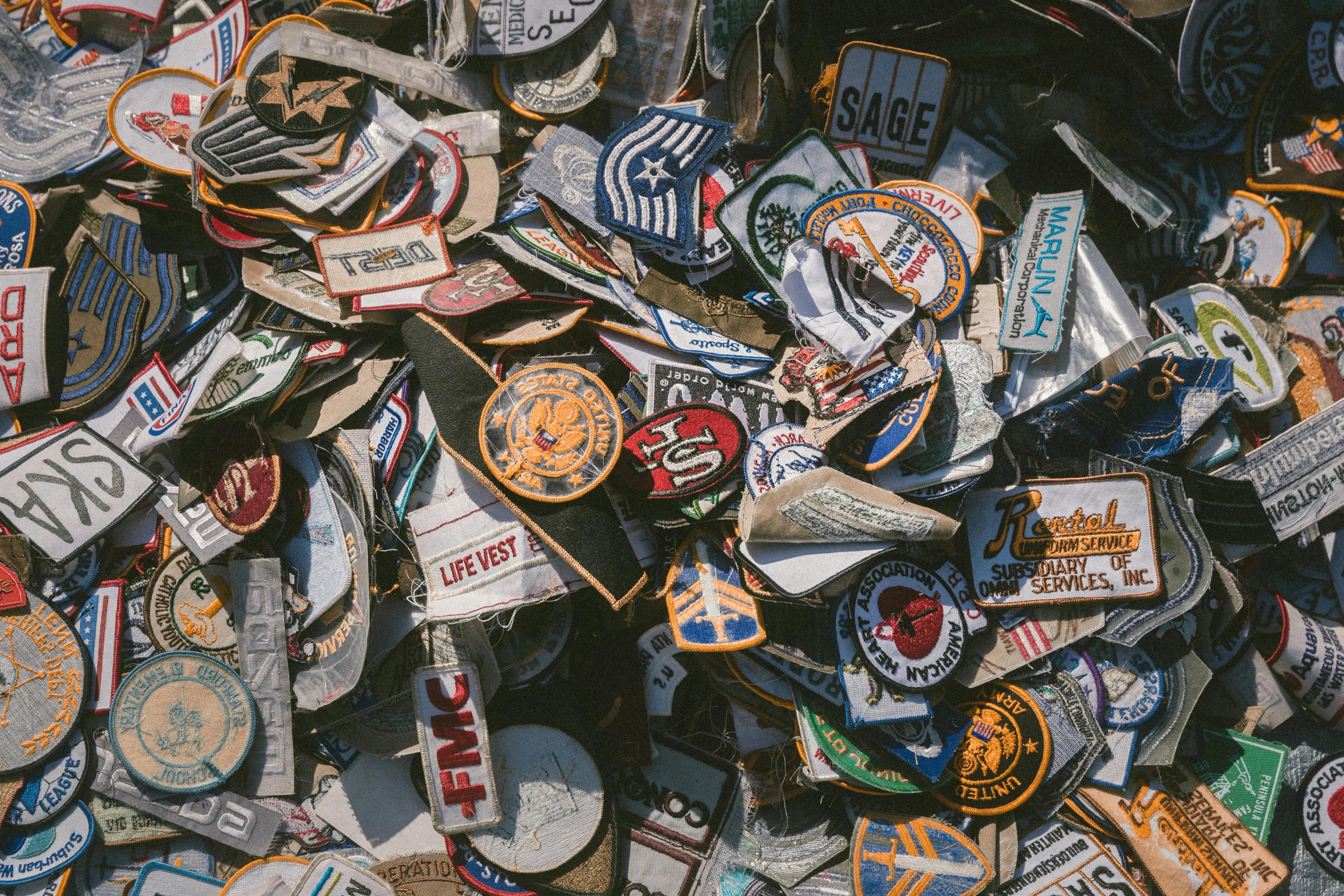 a pile of patches sitting on top of each other on a table .