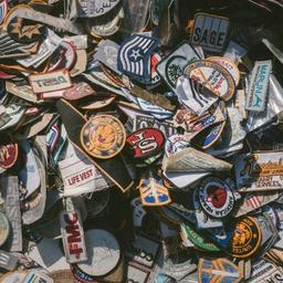 a pile of patches sitting on top of each other on a table .