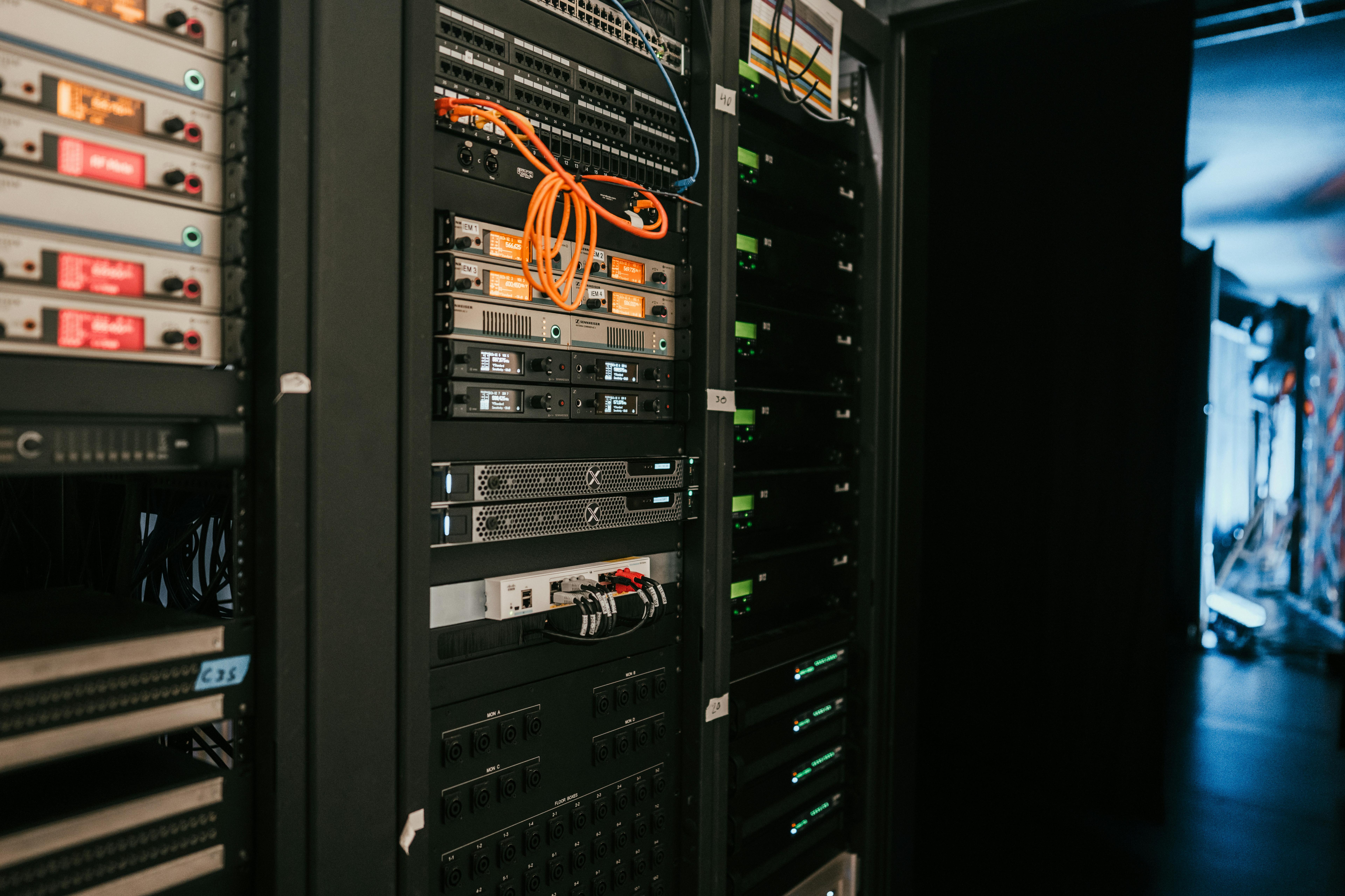 a server room filled with lots of servers and cables .