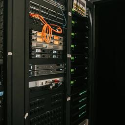 a server room filled with lots of servers and cables .