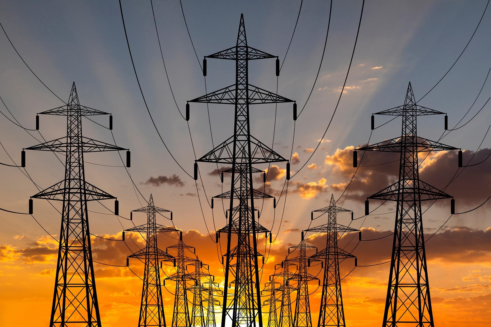 a row of power lines against a sunset sky .