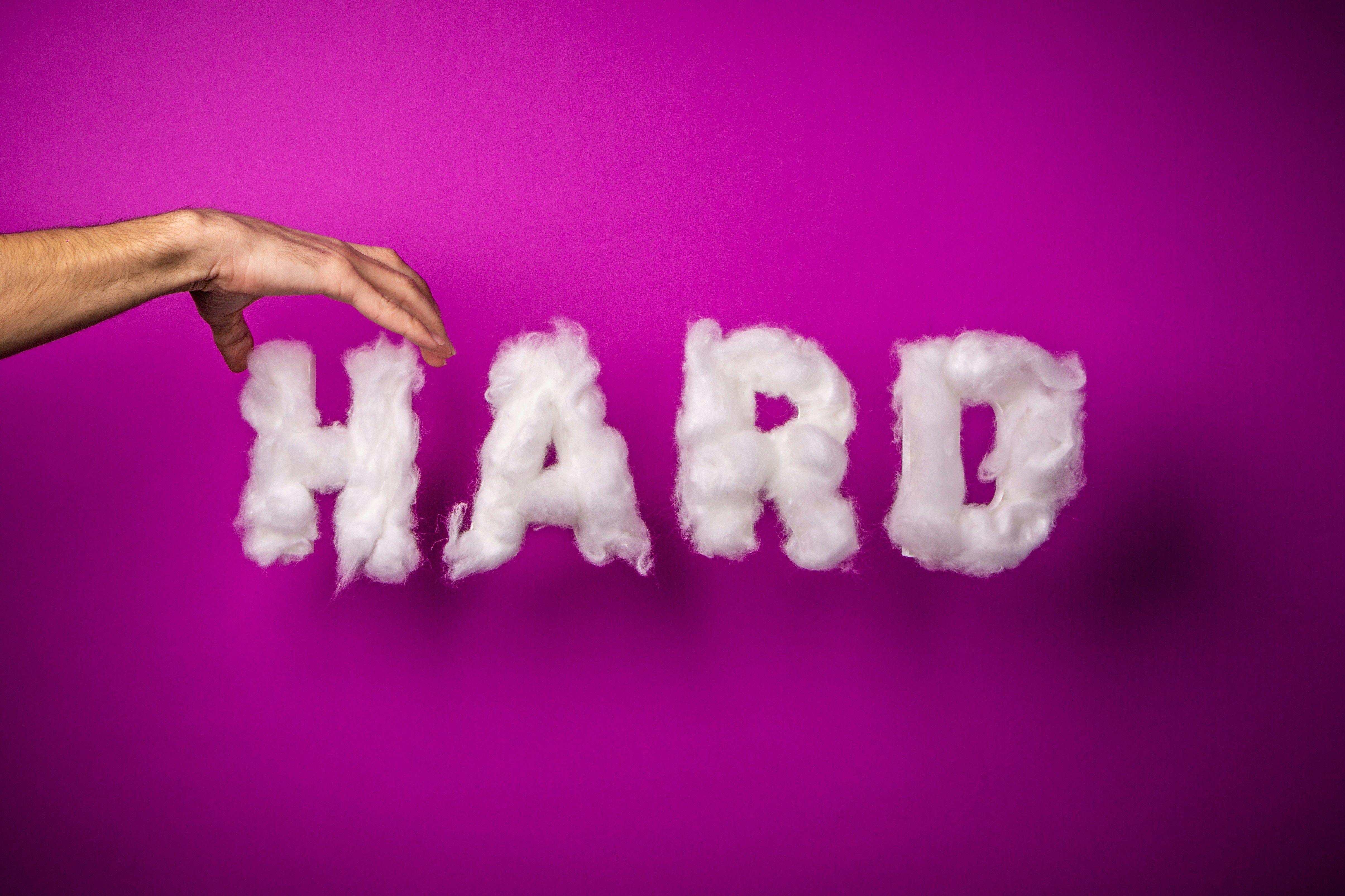 the word hard is made of clouds on a purple background .