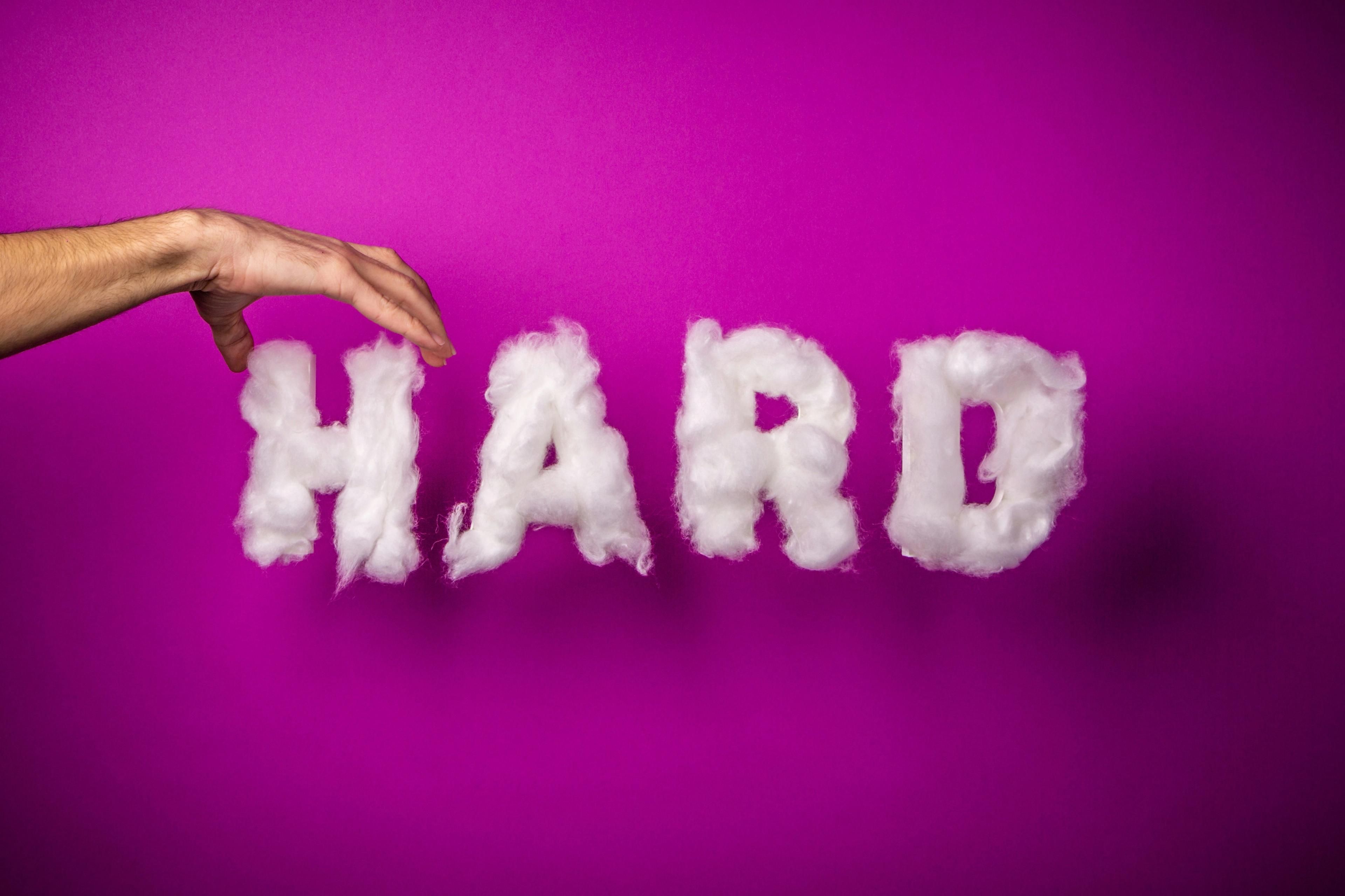 the word hard is made of clouds on a purple background .