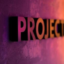 the word projects is on a purple and orange wall .