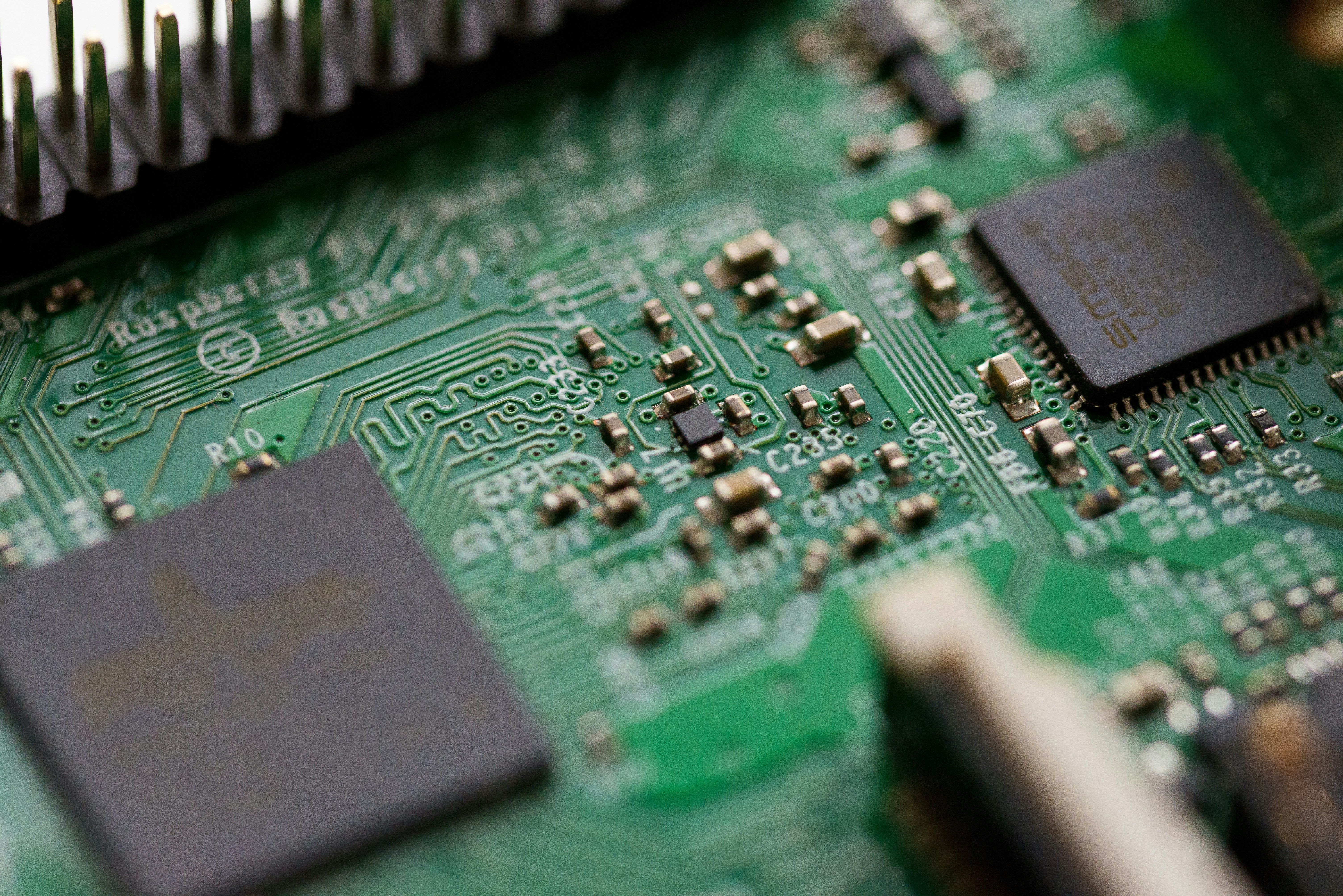a close up of a green motherboard with a lot of electronics on it .